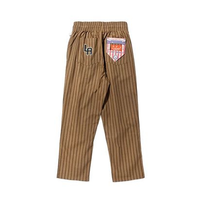 Brown pinstripe pants with a brand label on a white background