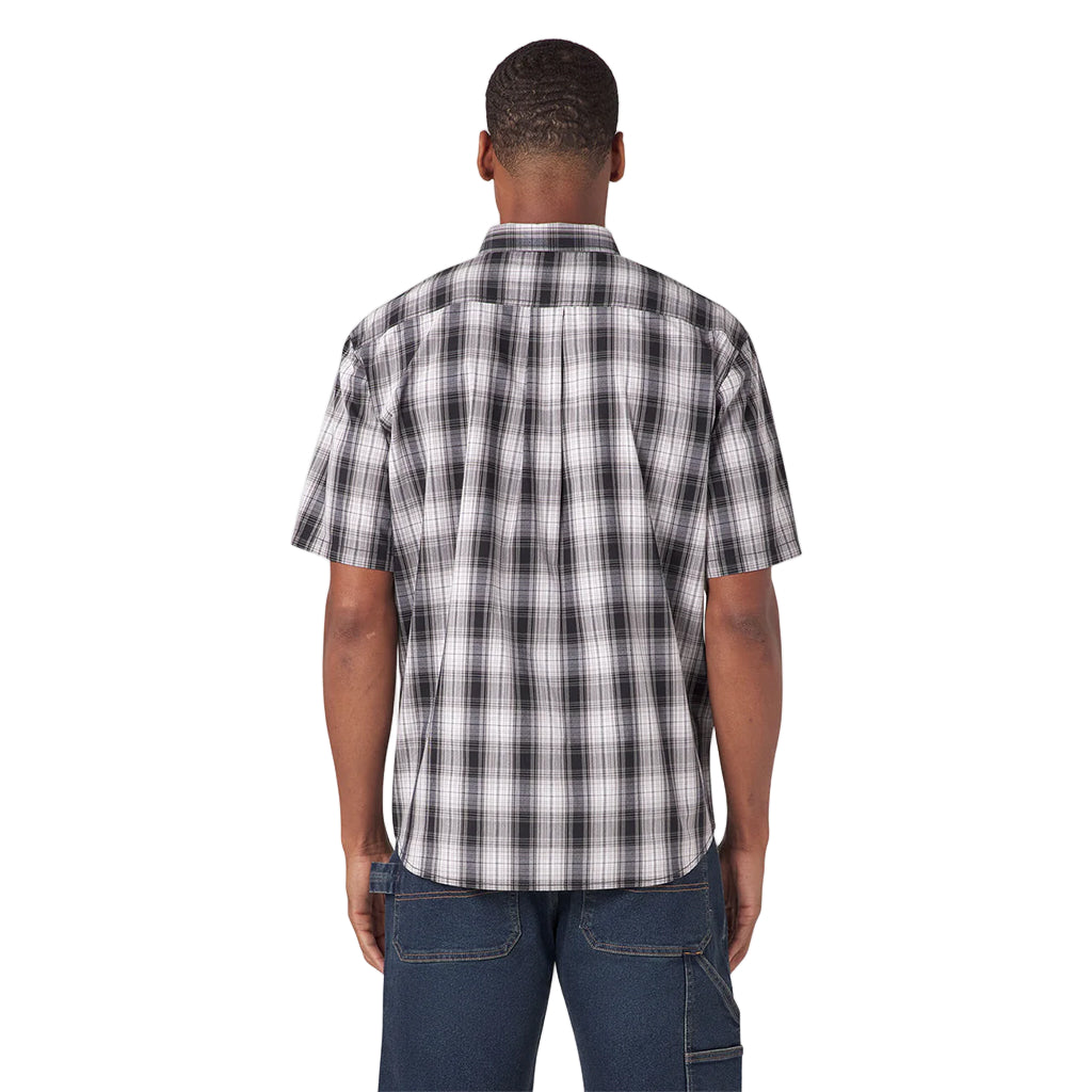 Man wearing a black and white plaid shirt on a white background