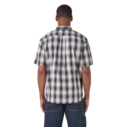 Man wearing a black and white plaid shirt on a white background