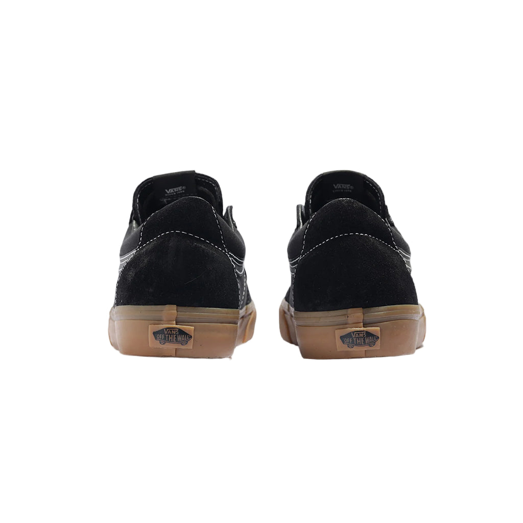 Black sneakers with brown soles on a white background