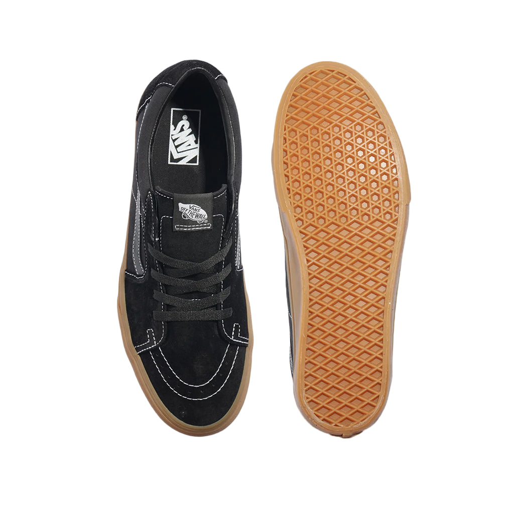 Black sneaker with a brown sole on a white background