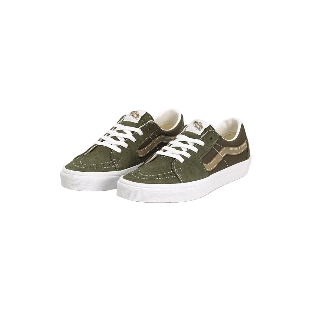 Pair of green sneakers with white laces on a light gray background