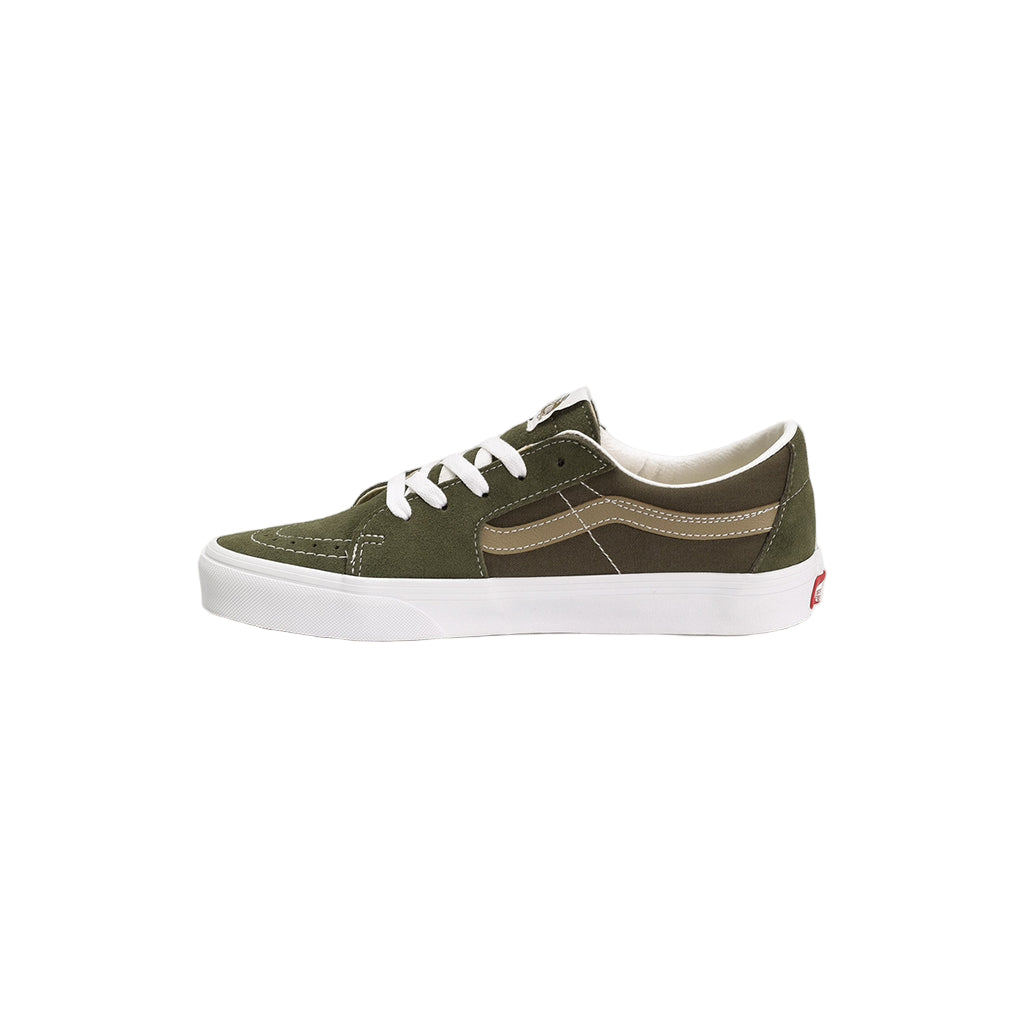 Green sneaker with white laces on a light gray background