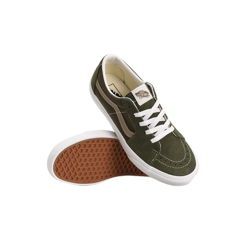 Green sneakers with white laces on a light gray background