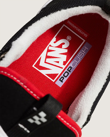 Close-up of a Vans shoe with red lining and white sole.