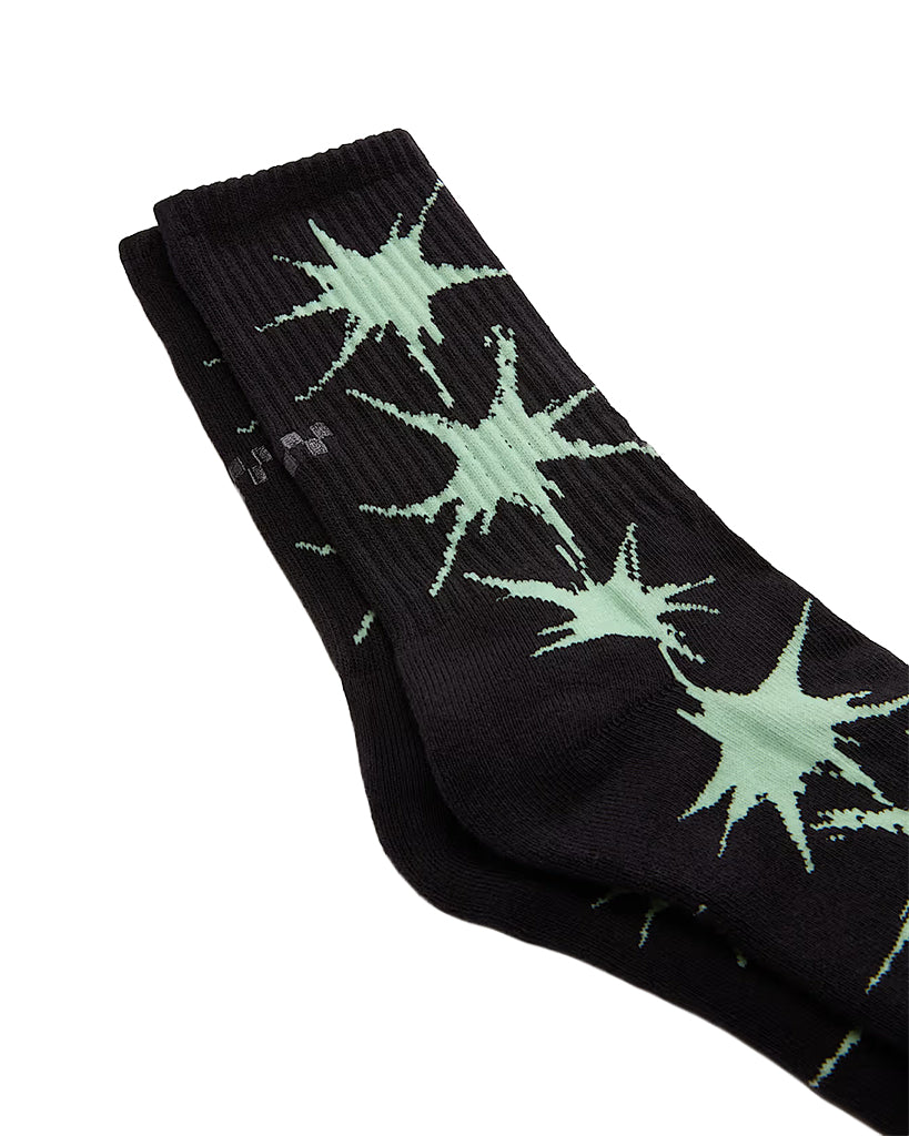 Black socks with green star patterns on a white background