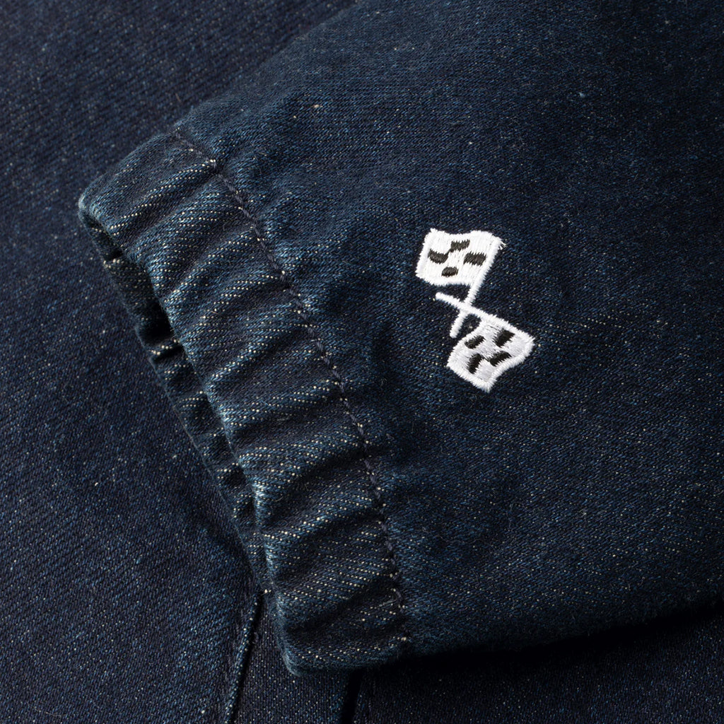 Close-up of a dark fabric with white embroidered design on a black background