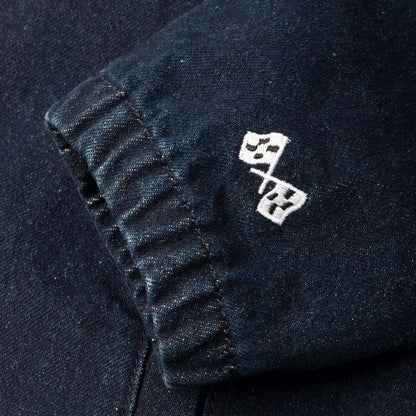 Close-up of a dark fabric with white embroidered design on a black background