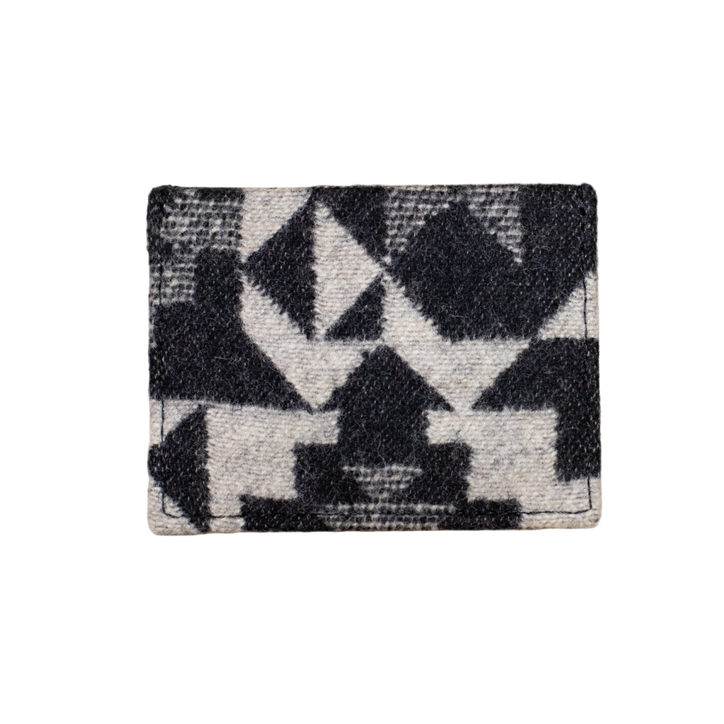 Black and white geometric patterned rug on a wooden floor