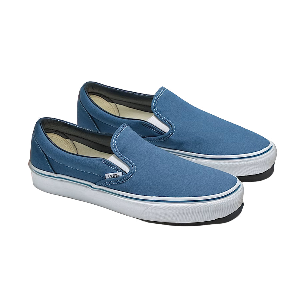 Pair of blue slip-on shoes on a white background
