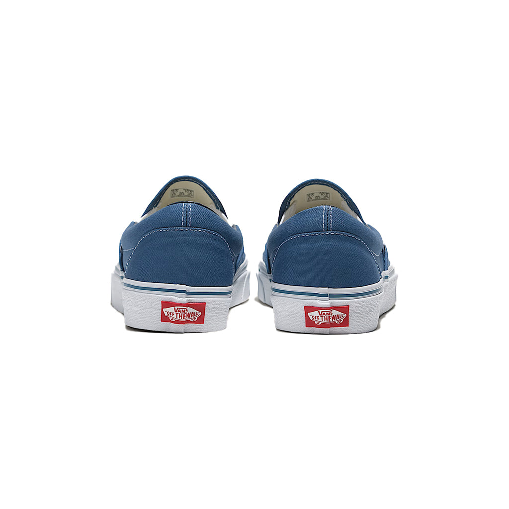 Blue slip-on sneaker with brown sole on a white background