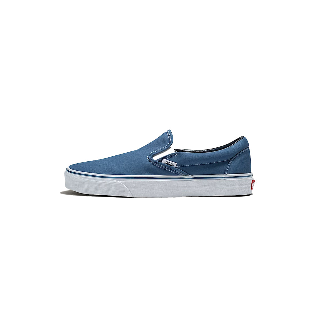 Blue slip-on sneaker with brown sole on a white background