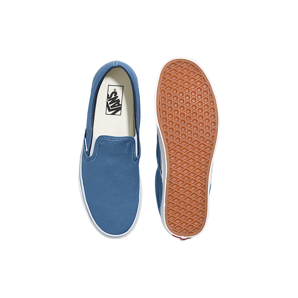 Blue slip-on sneaker with brown sole on a white background