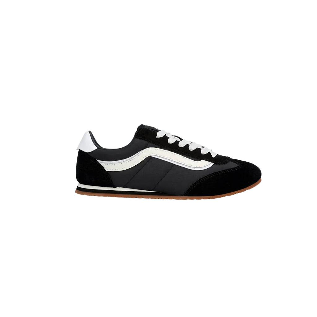Black and white sneaker with a brown sole on a white background
