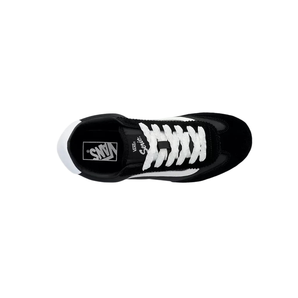 Black and white sneaker with visible brand logo on a white background