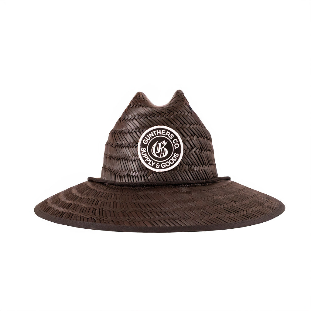Black straw hat with a Gunthers logo patch on a white background