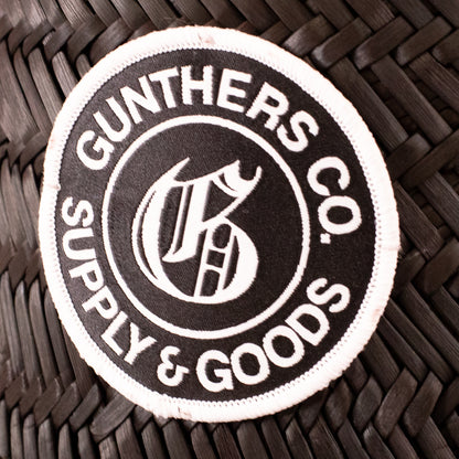 Round patch with 'Gunthers Co. Supply & Goods' text and logo on a woven surface