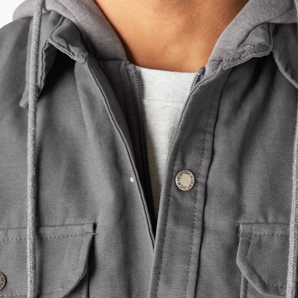 Close-up of a gray jacket with a brand logo on a white background