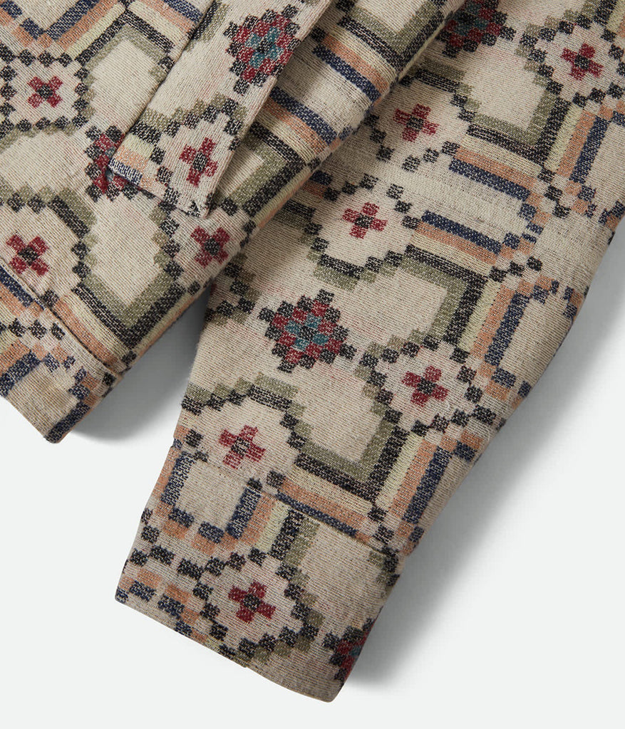 Close-up of patterned fabric with geometric design on a white background