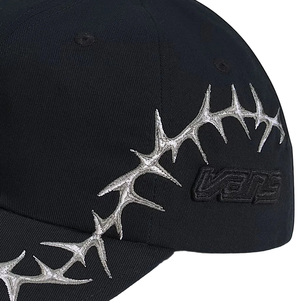Black cap with silver antler design and Vans logo on a white background