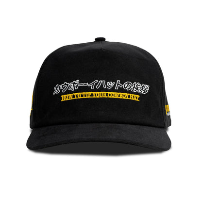 Black cap with yellow text on a white background