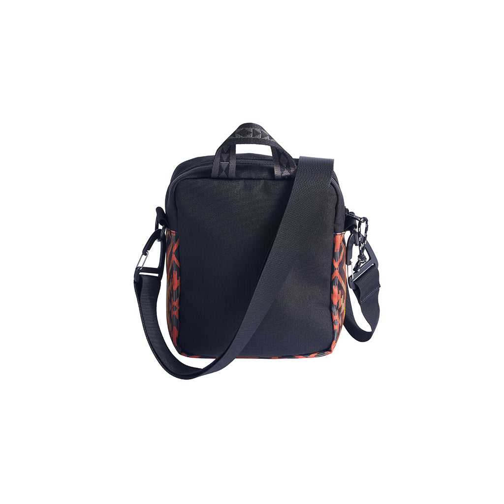 Black crossbody with a colorful pattern on the strap against a white background