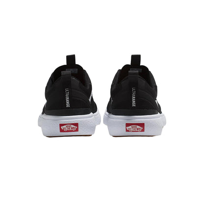 Black sneakers with red Vans logo on a white background