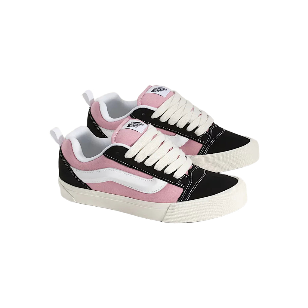 Pair of black, pink, and white sneakers on a light gray background