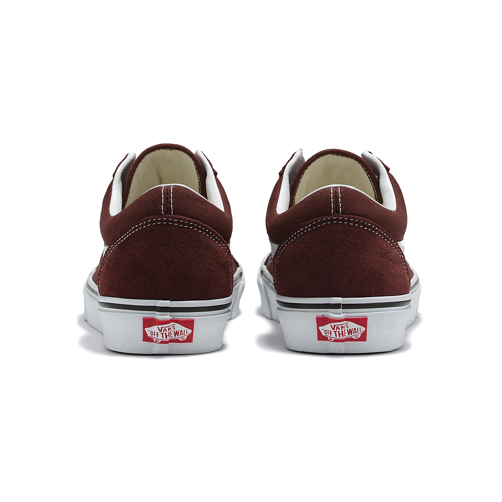 Brown sneakers with white soles and red labels on a white background