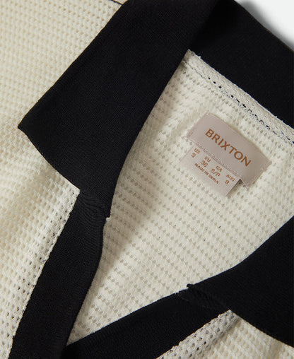Close-up of a Brixton bag with a textured surface and visible brand label.