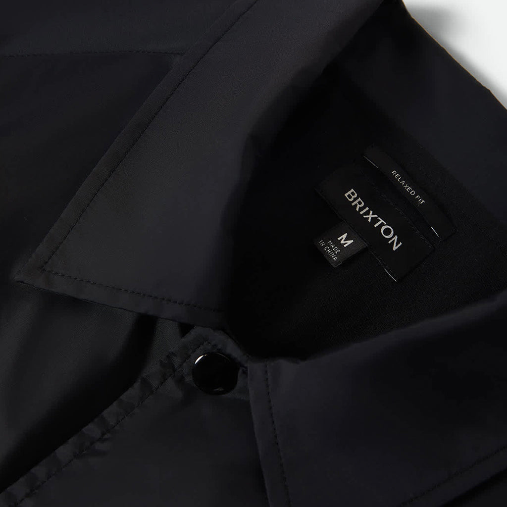 Black jacket with a Brixton label on a white background