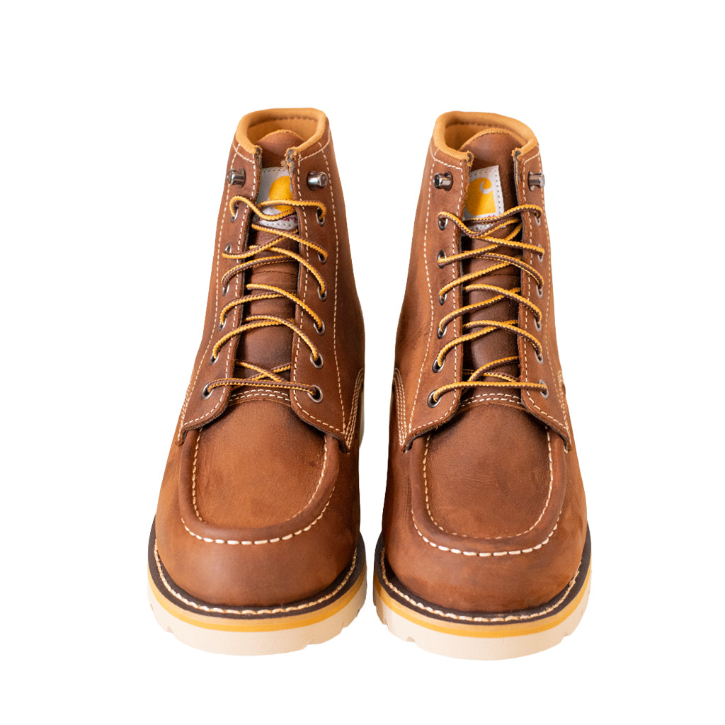 Pair of brown leather boots with yellow laces on a white background