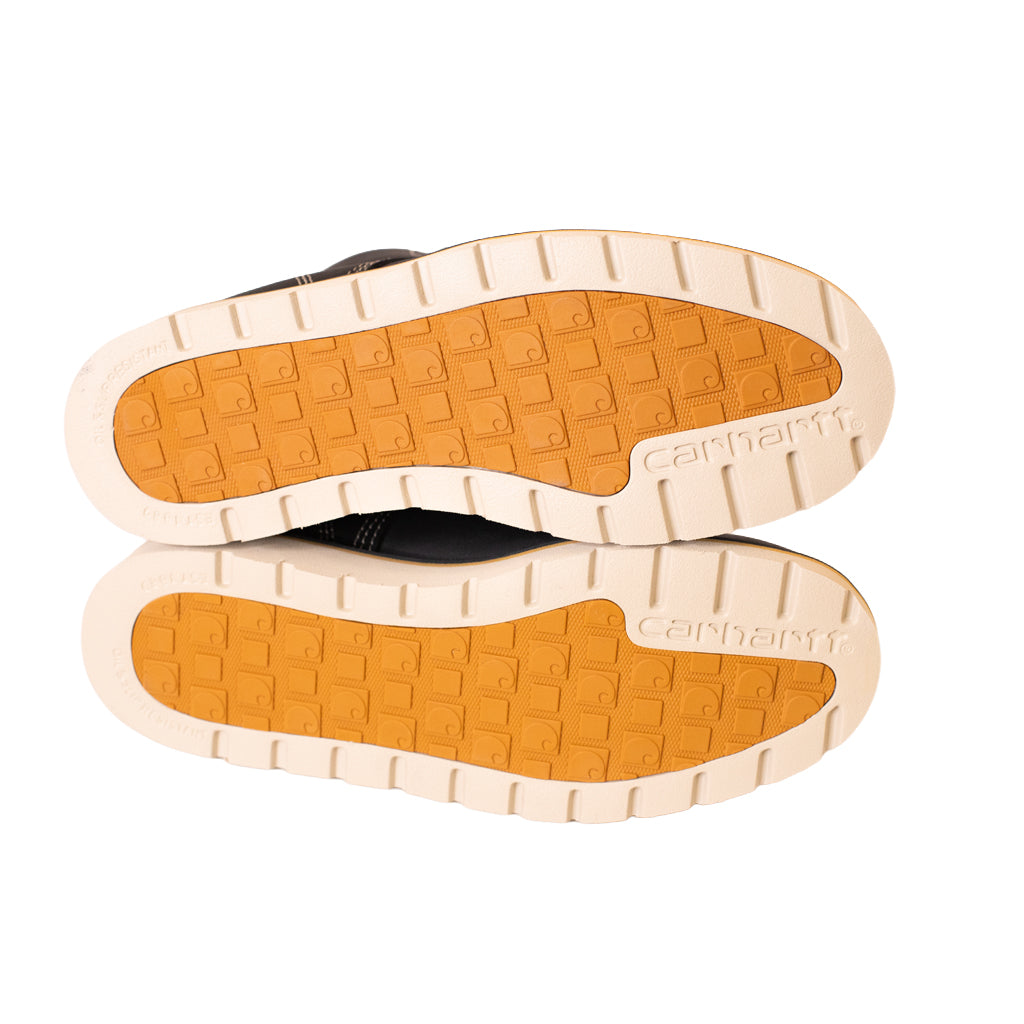 Close-up of a pair of shoes with a visible brand name on the sole against a white background