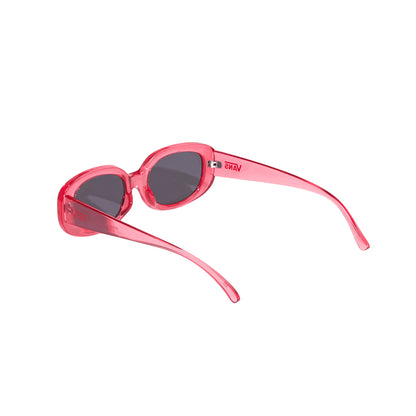 Pink sunglasses with dark lenses on a white background