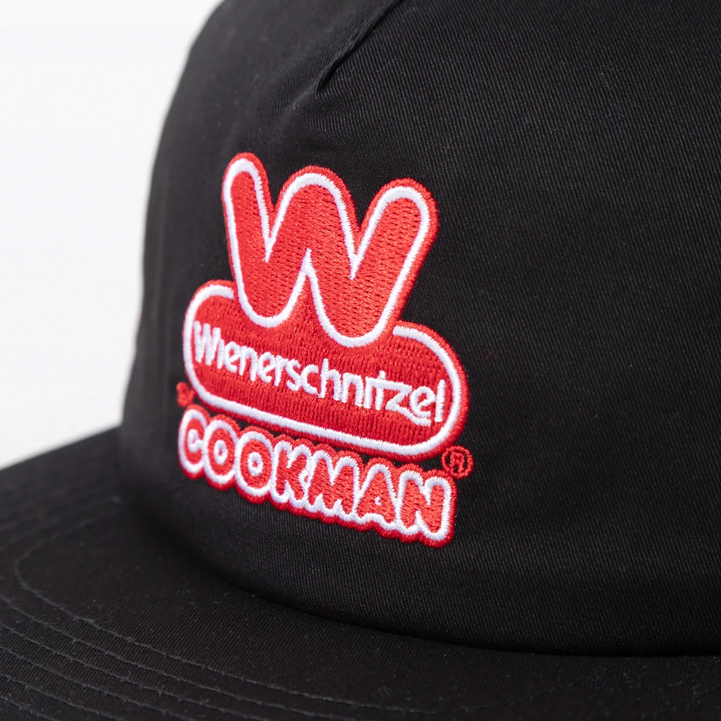 Close up of the Wienerschnitzel Cookman Logo on a black snapback