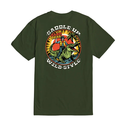 Green t-shirt with a graphic design of a person riding a Alligator  and text on the back, on a white background.