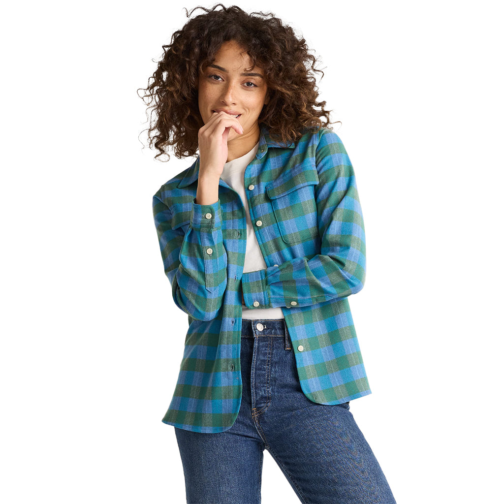 Person wearing a blue and green plaid shirt on a white background