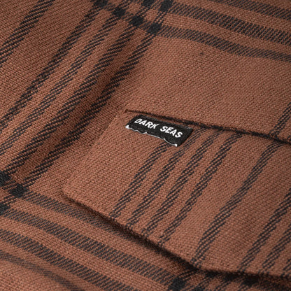 Brown plaid fabric with a 'Dark Seas' label