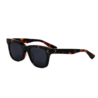 Sunglasses with tortoiseshell frame and dark lenses on a white background