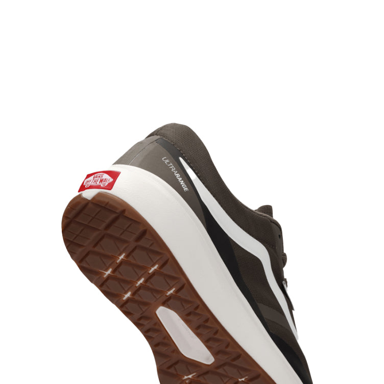 Close-up of a brown and black sneaker with a white sole on a white background