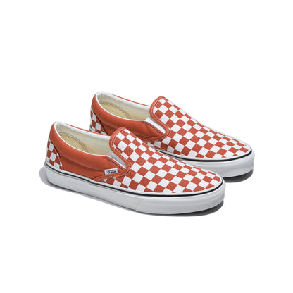 Pair of red and white checkered slip-on shoes on a white background