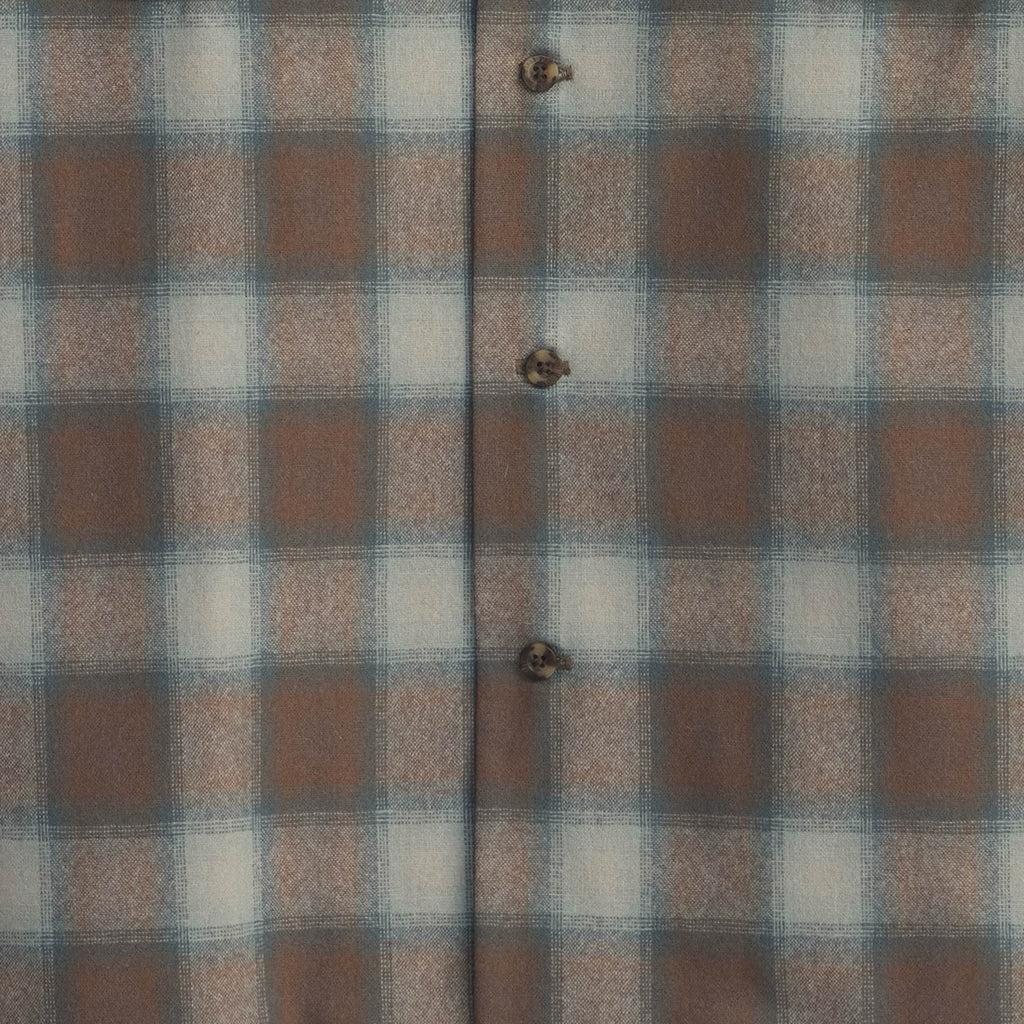 Plaid fabric with brown, blue, and white squares