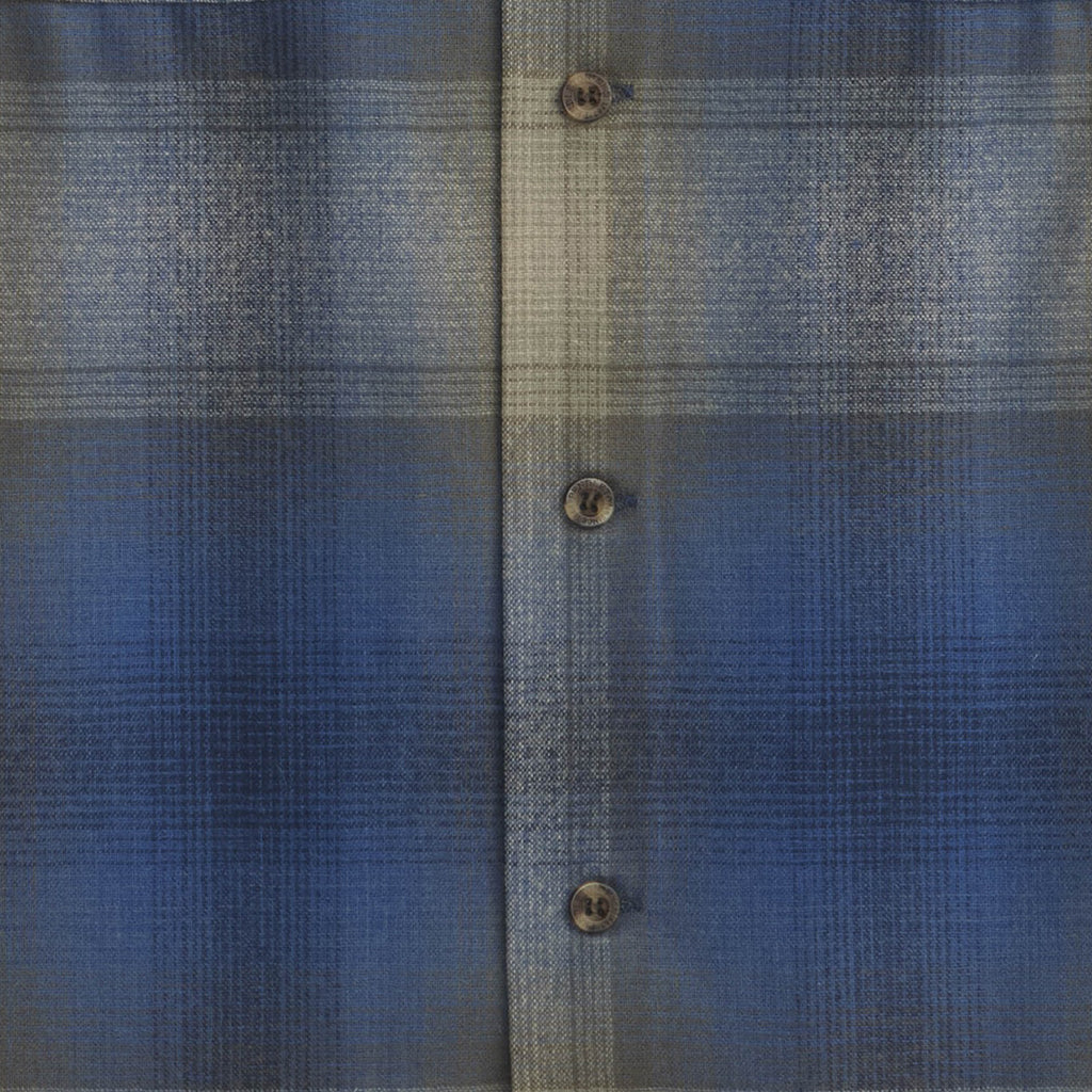 Close-up of a blue textured fabric with button details