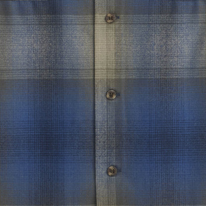 Close-up of a blue textured fabric with button details