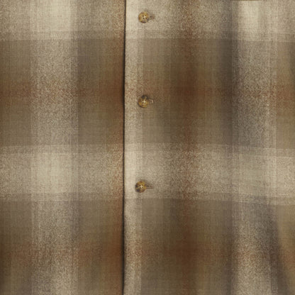 Close-up of a textured fabric with plaid pattern and buttons.