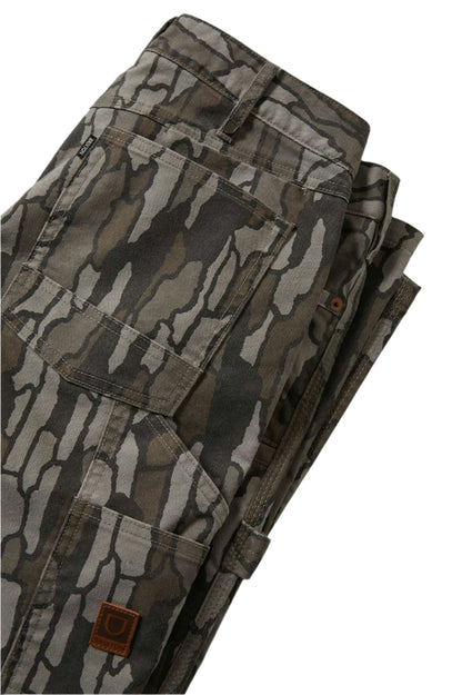 Folded camouflage pants on a white background