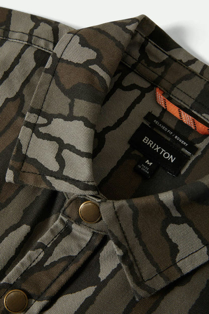 Camouflage jacket with Brixton logo and branding on a white background
