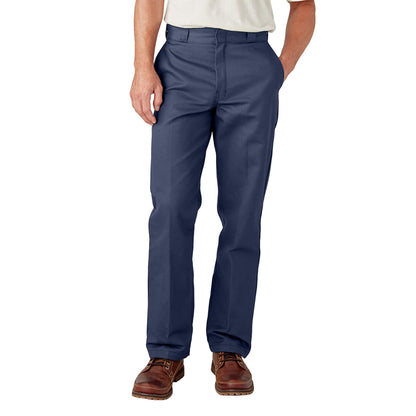 A person standing with hands in pockets wearing navy Dickies men's original 874 work pants.