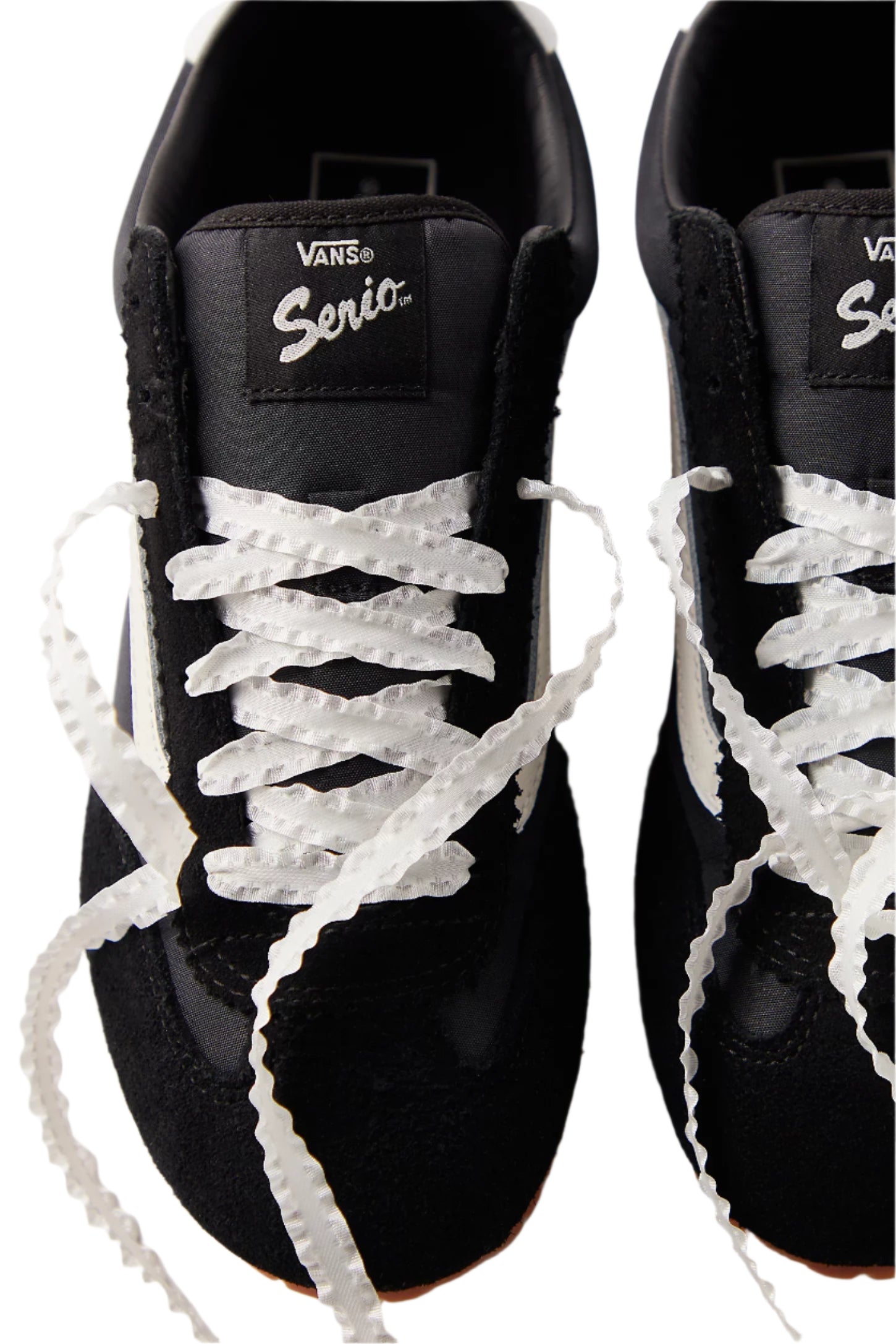 Black sneakers with white laces and Vans logo on a white background
