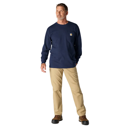 Man wearing a navy long-sleeve shirt and beige pants on a white background